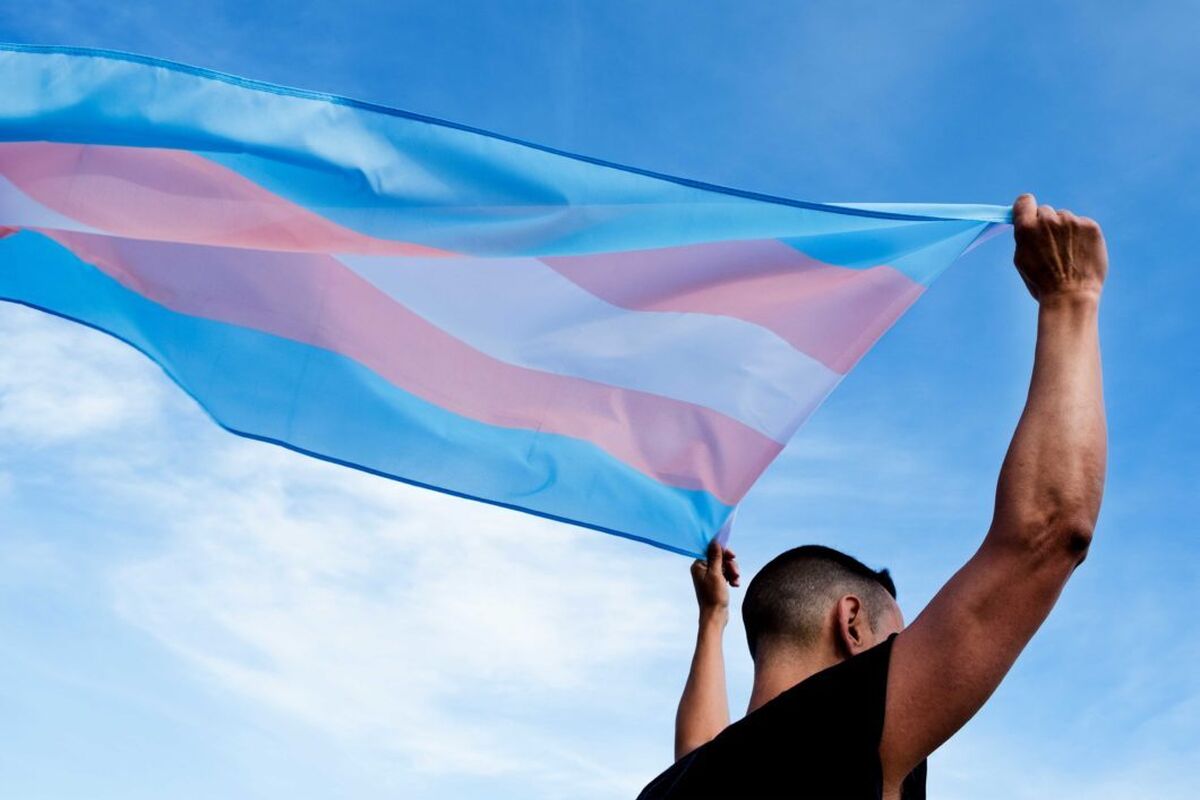 Trans work image person with trans flag